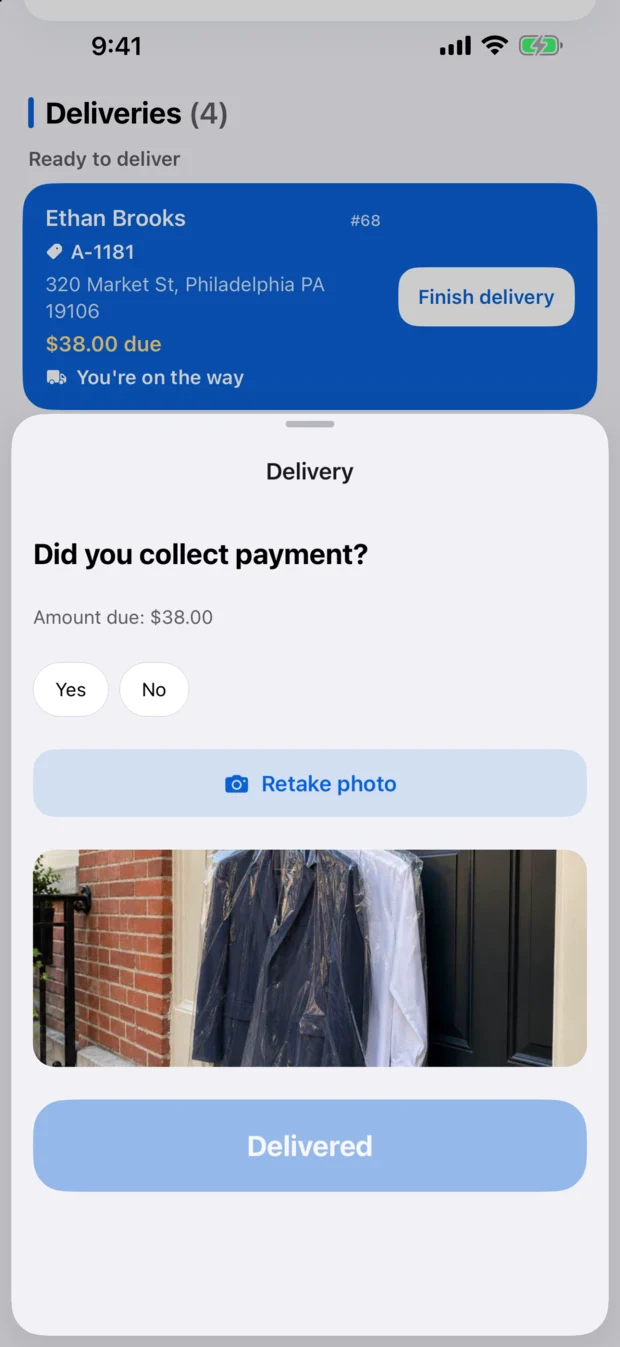 Finishing a delivery in CR Business: the driver's photo of garments hanging on a customer's door, attached before tapping Delivered.